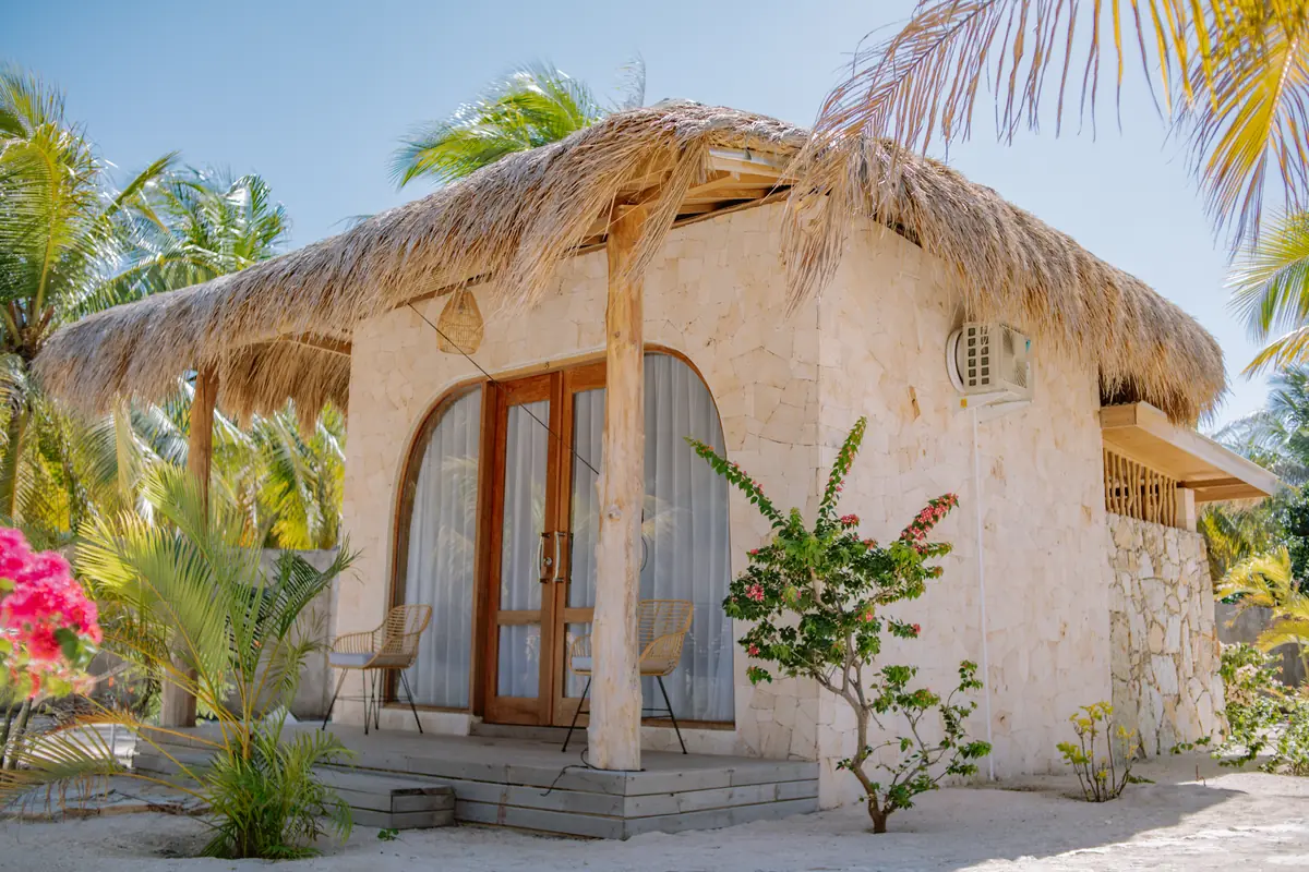 Arched doors and bougainvillea at the front of a Garden Bungalow