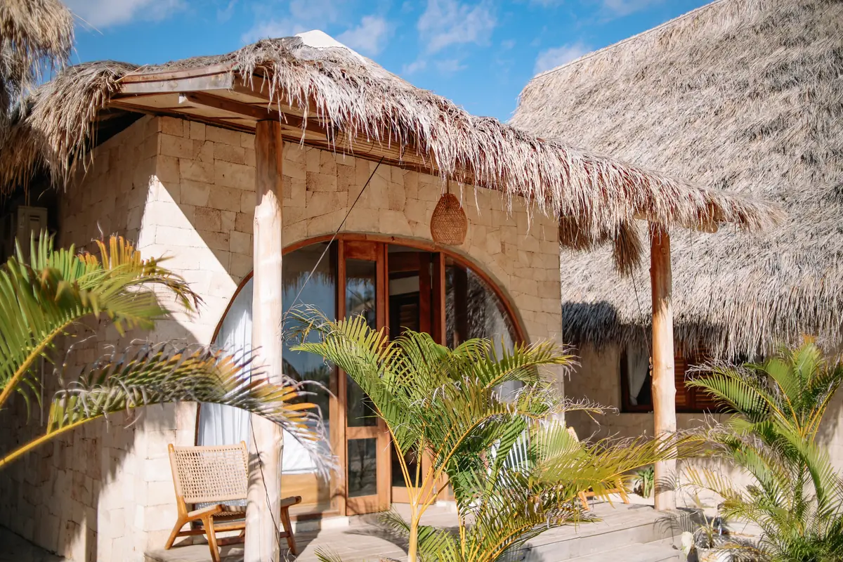 Shaded terrace with rattan chair outside an Oceanfront Room