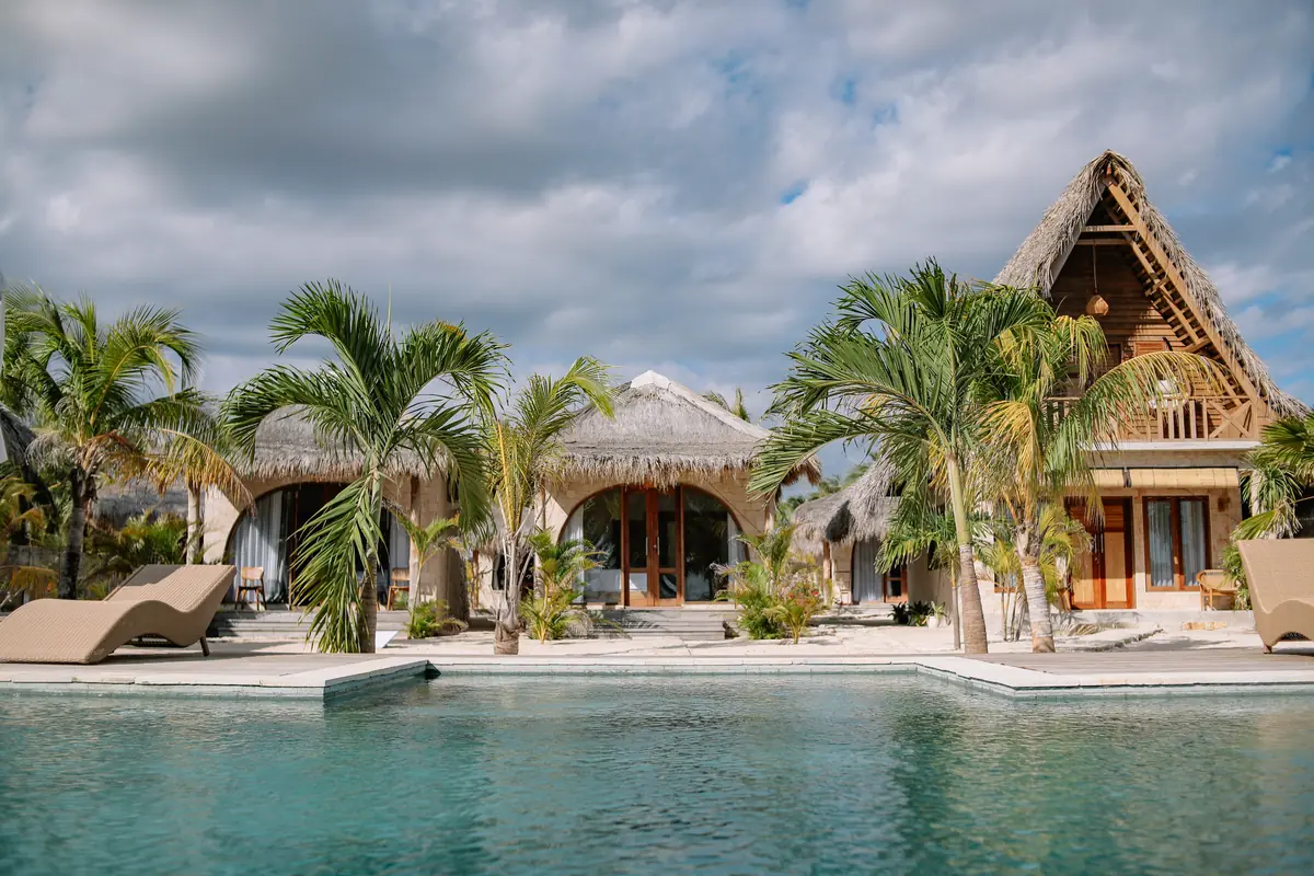 The pool with the Family Room and bungalows behind