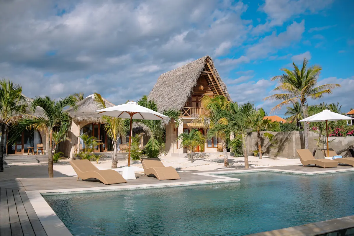 Loungers and umbrellas along the pool, the Family Room behind